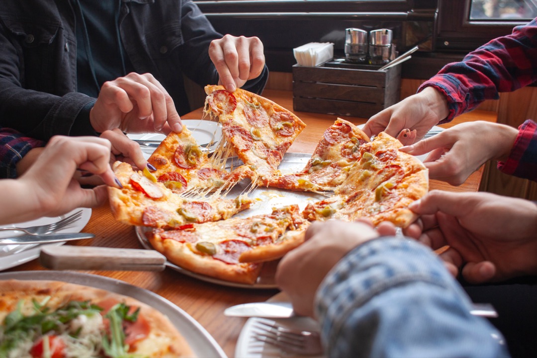 Group of people sharing pizza